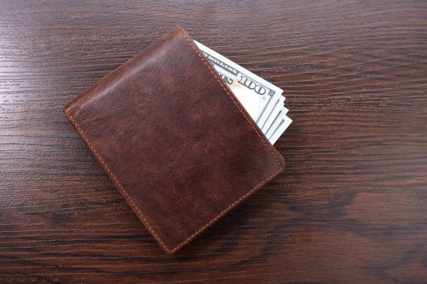 istock Wallet with money on wooden background. Closeup 874301740