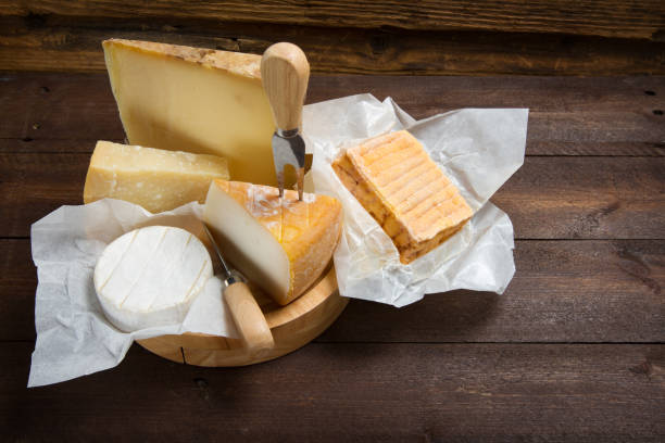 istock Various types of cheeses on a wooden table 874301766