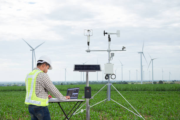 engineer using tablet computer collect data with meteorological instrument to measure the wind speed, temperature and humidity and solar cell system on corn field background, smart agriculture technology concept - anemometer meteorology measuring wind imagens e fotografias de stock