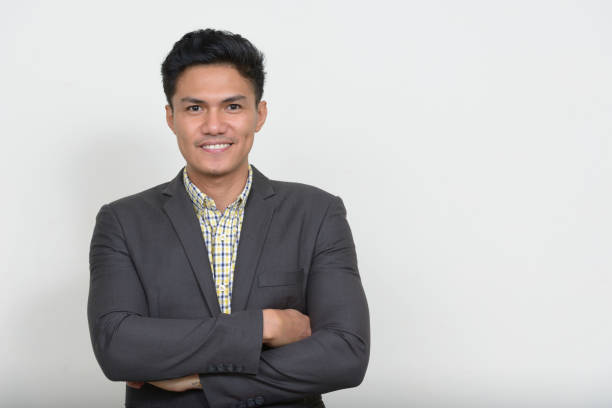 istock Young Asian businessman wearing suit against white background 874304672