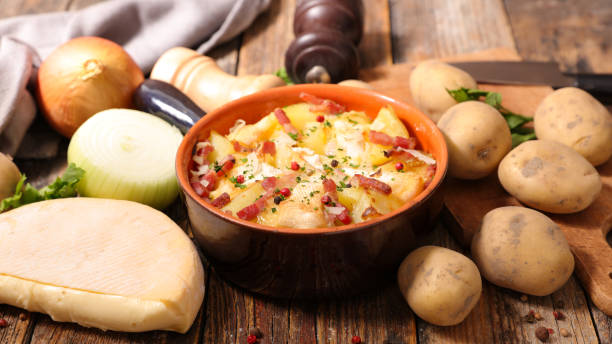 istock tartiflette, baked potato with cream,bacon and cheese 874306070