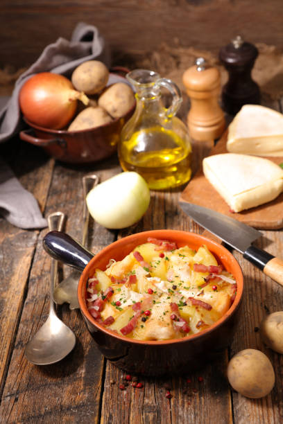 istock tartiflette, baked potato with cream,bacon and cheese 874306088