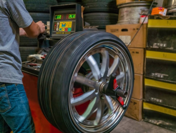 istock The mechanic using computerize wheel balancer to balance the wheel 874308814