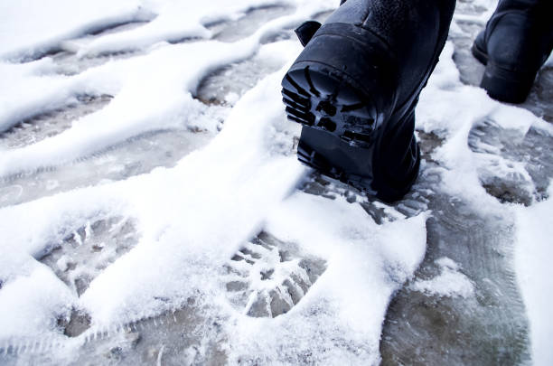 Dirty footprints in the snow winter. Track from boots on the tra
