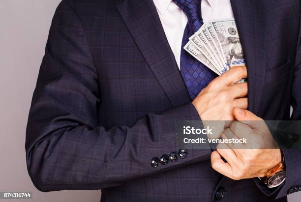 Businessman Putting Money In Suit Jacket Pocket Stock Photo - Download Image Now - Currency, Stealing - Crime, Wages