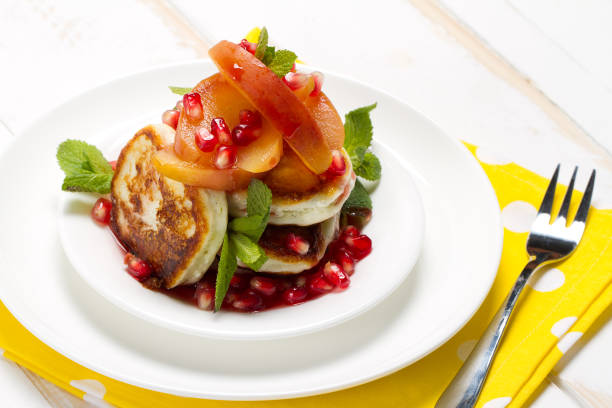 istock Cottage cheese and vanilla pancakes with apple compote, pomegranate grenadine and mint 874316906