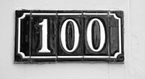 sign with the number 100 made with glossy tiles