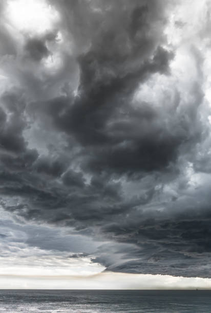 istock Approaching storm cloud with rain over the sea 874320998