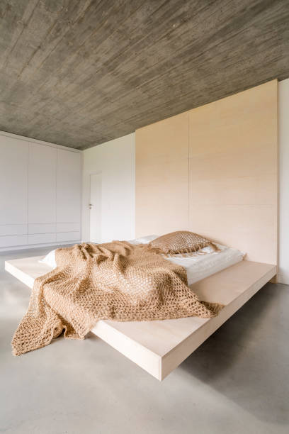 istock Bed on wooden platform 874321224