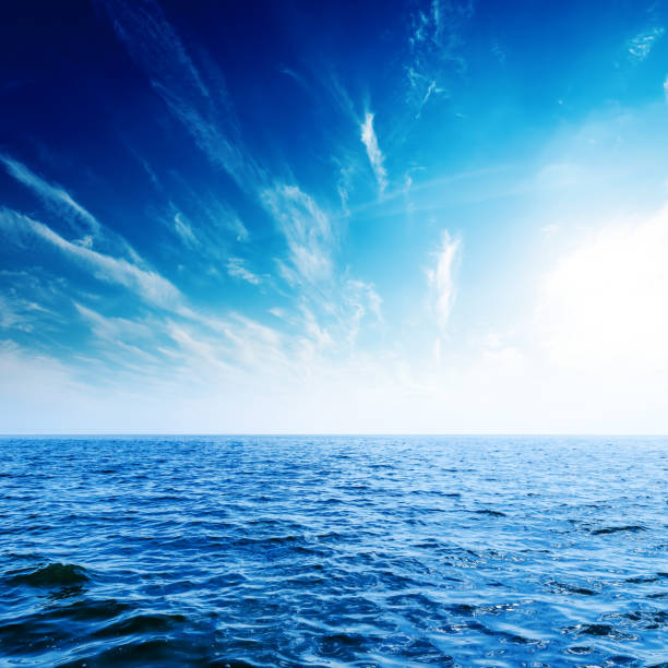 istock sunset in deep blue sky with clouds over sea 874321458