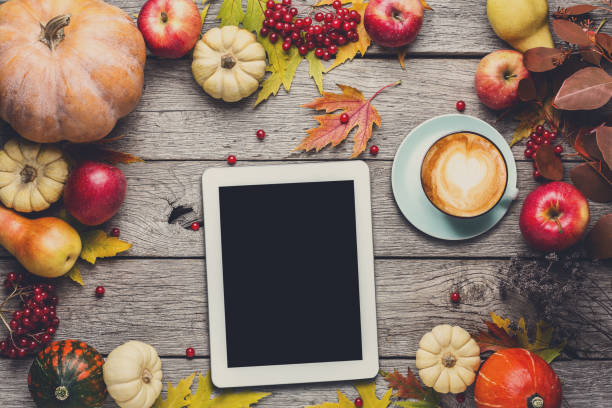 istock Seasonal background with autumn harvest and tablet 874321944
