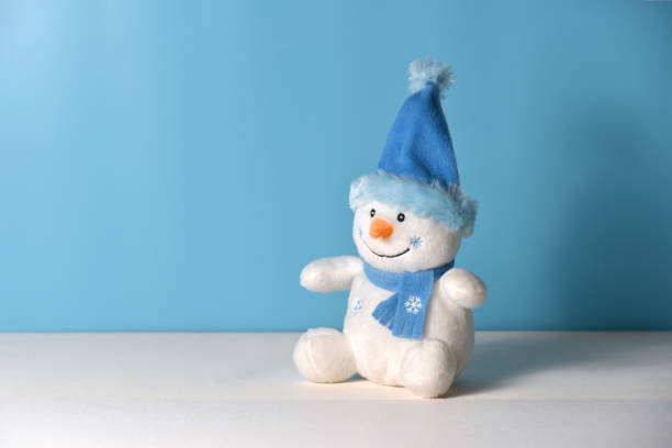 istock Christmas background with toy snowman on a blue background 874322150