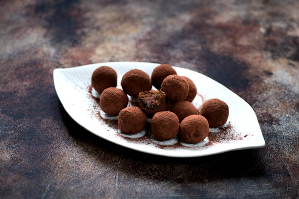 istock Candy chocolate truffles with chocolate cream and nuts 874326554