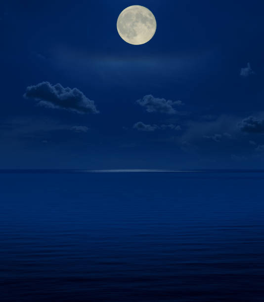 istock full moon in night over sea 874327276
