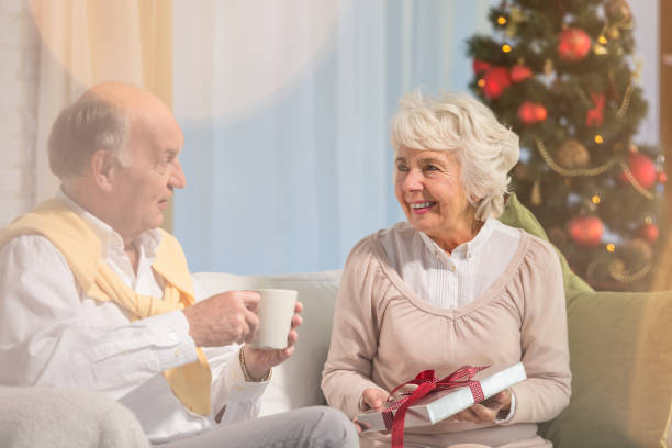 istock Elderly people giving presents 874327520