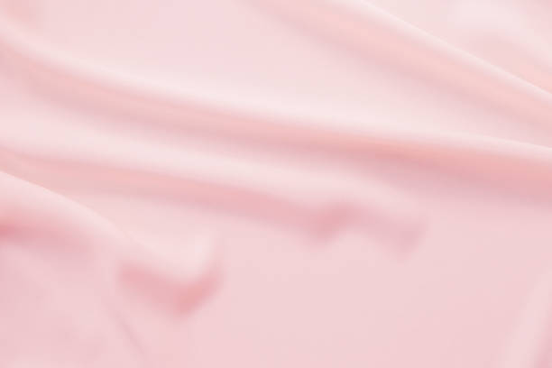 istock Abstract background of waving pink fabric texture 874327692