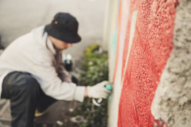 istock Graffiti Artist Spraying on the Wall 874327858