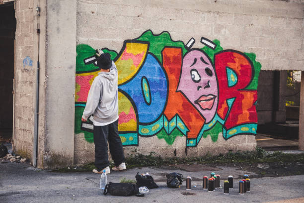 istock Graffiti Artist Spraying Paint 874327956