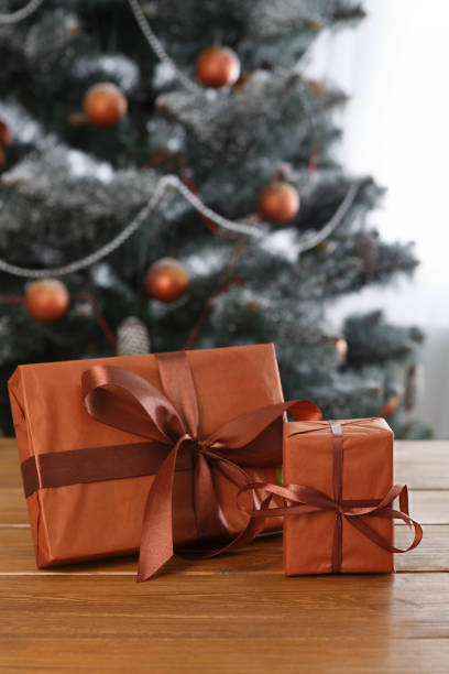 istock Christmas present on decorated tree background, holiday concept 874328644