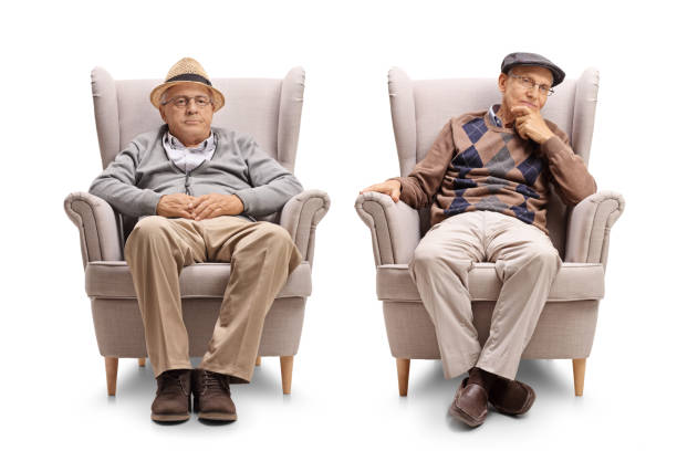 istock Two elderly men seated in armchairs 874330994