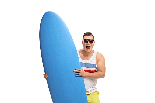 Joyful surfer holding a surfboard isolated on white background