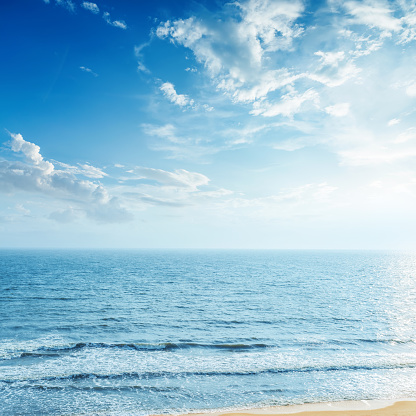 blue sky with clouds and sea in sunset