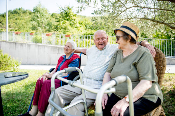 istock Seniors Socializing Outdoors in a Park 874332266