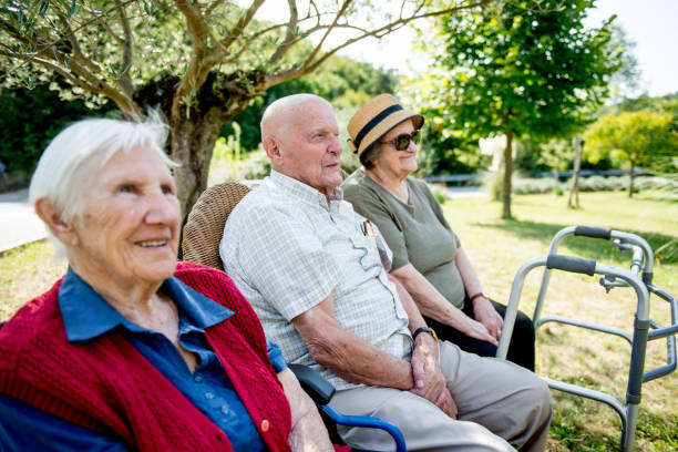 istock Seniors Socializing Outdoors in a Park 874332270