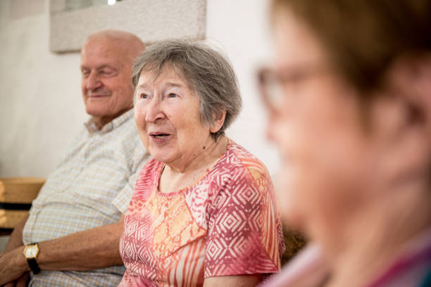 istock Group of Seniors Socializing Indoors 874332350