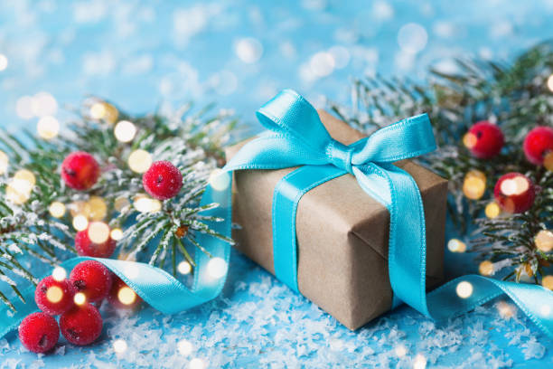 istock Gift box or present and snowy fir tree for christmas greeting card. 874332866