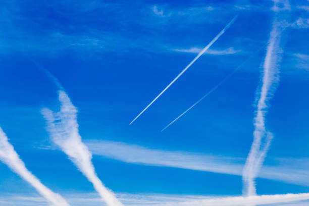 istock traces of an airplane on a blue sky 874333256