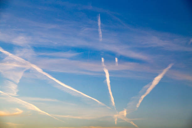 istock traces of an airplane at sunset as background 874333610