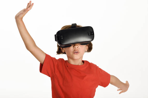 istock Little girl looking in VR glasses and gesturing with his hands. 874333728