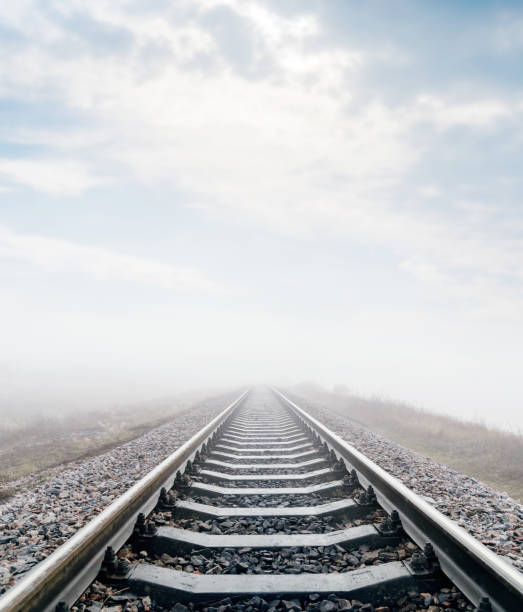 istock railroad in meadow with fog and clouds over it 874339008