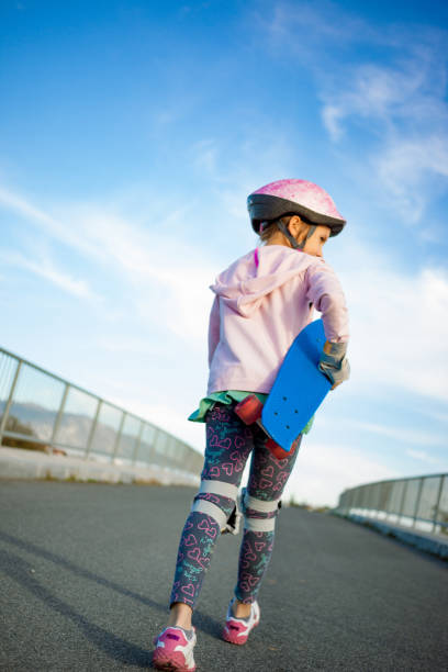 istock Playful Girl And Her Skateboard 874340732