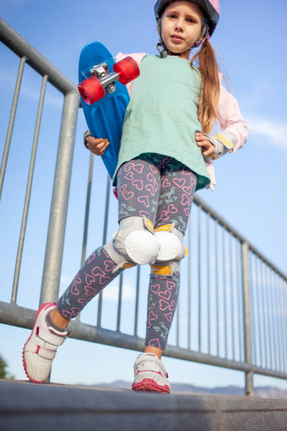 istock Playful Girl And Her Skateboard 874341468