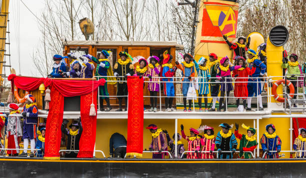 Sinterklaas arriving by steam ship with his Piet Helpers The arrival of Sinterklaas in the city of Meppel on the steam boat Pakjesboot 12 coming from Spain. Sinterklaas is standing on the boat’s bow surrounded by his helpers the  Black Petes. The arrival in Meppel is the official arrival of Sinterklaas in The Netherlands for 2015 and is broadcasted on national television. Sinterklaas is a traditional Dutch holiday for children that is celebrated on the 5th of December. zwarte piet stock pictures, royalty-free photos & images