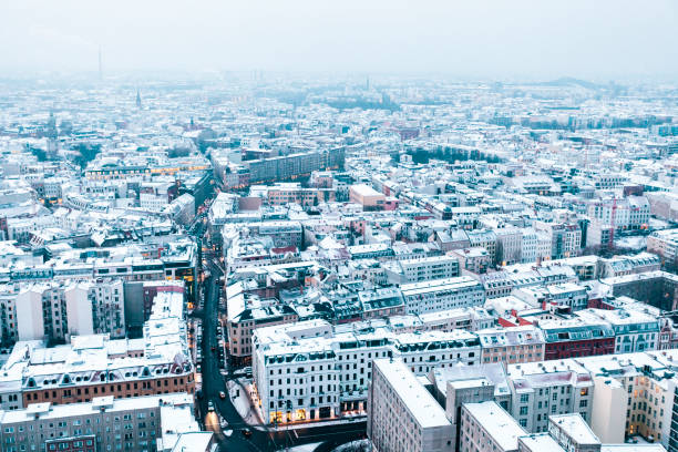 istock Aerial view of snow covered rooftops at dusk, Berlin, Germany 874346296