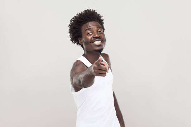 istock Hey you! Man in white t-shirt showing finger at camera. 874346830