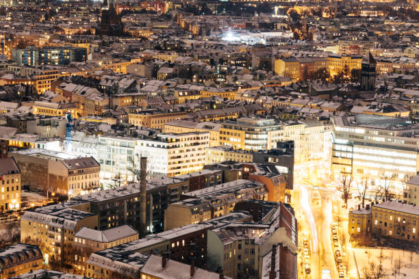 istock Aerial view of snow covered rooftops at night, Berlin, Germany 874348756