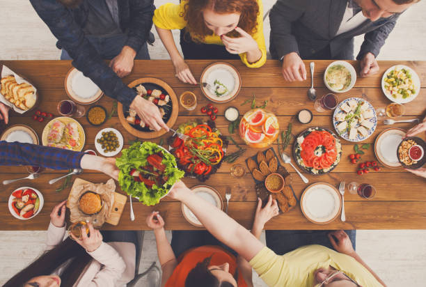 istock People eat and share healthy meals at served table dinner party 874348766