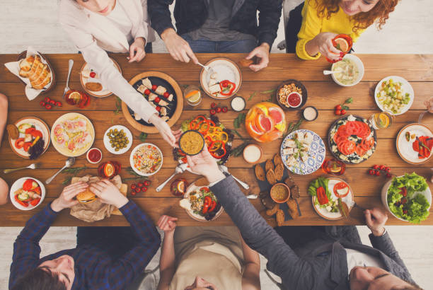 istock People eat healthy meals at served table dinner party 874348828