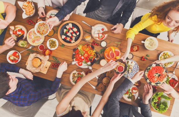 istock People eat healthy meals at served table dinner party 874348898