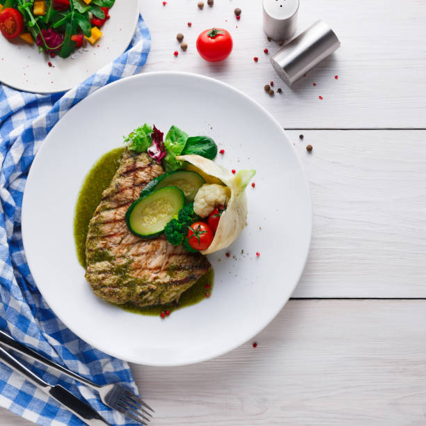 istock Grilled beefsteak with vegetables and green bell pepper sauce 874353432