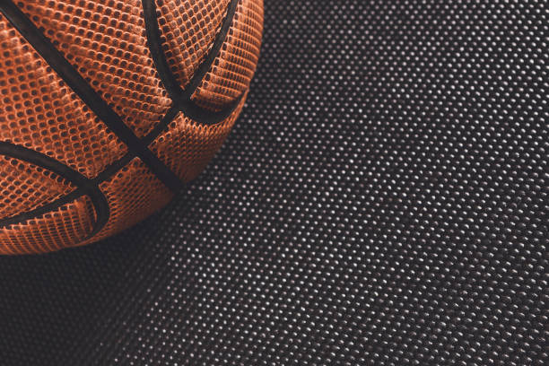 istock Old basketball ball on black background copy space 874356622