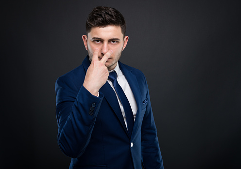 Young director in formalwear keeping eyes on you or trying to intimidate you