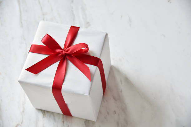 istock Top view of white gift boxes with red ribbon. 874359292