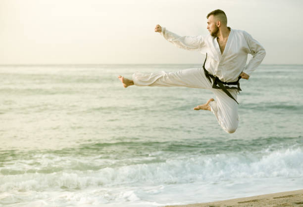 istock Adult man is training kick in jump 874363938