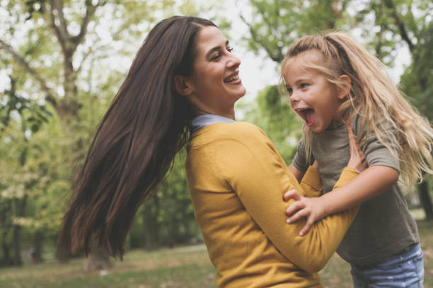 istock Mother carrying daughter have play. 874364370