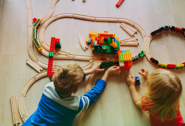 istock kids playing with toy railroad and trains 874367412